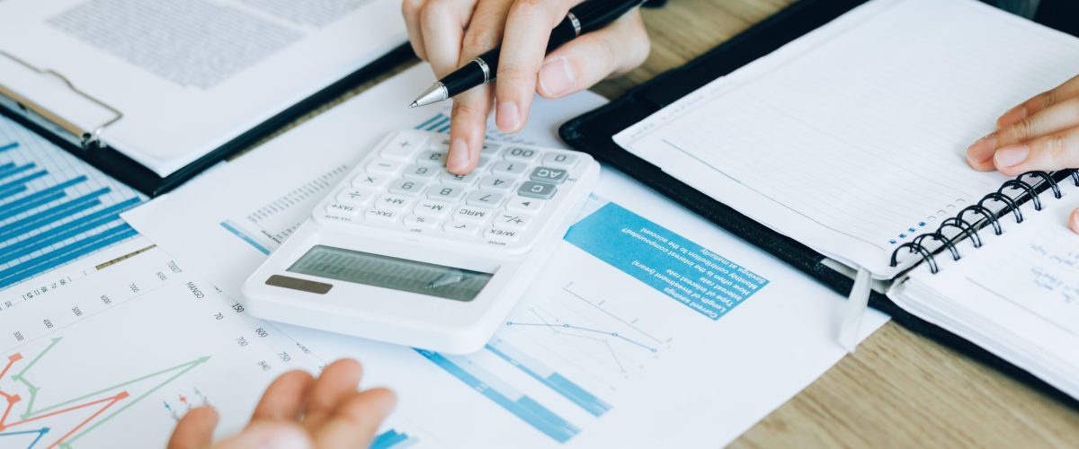 Manager calculates about the company finances by pressing on the